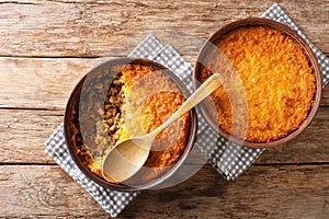Pastel de choclo corn pie is a Chilean dish based on sweetcorn and beef closeup in the pots. Horizontal top view photo