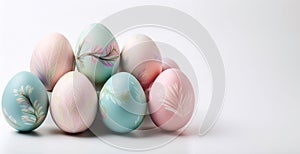 Pastel decorated easter eggs with floral patterns on white background, copy space