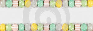 Colorful Easter banner with double row border of Easter Eggs over a white background with copy space