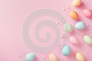Pastel Easter eggs on pink background top view. Flat lay style