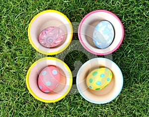 Pastel Eggs with 4 Cups in Grass background