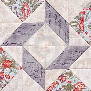 Pastel geometric patchwork block from pieces of fabrics, detail of quilt, close-up
