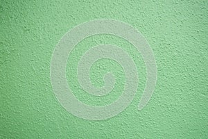 Pastel green plastered wall texture background