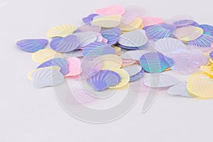 Pastel colours iridescent shell confetti isolated on white