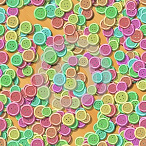 Pastel multi colored vintage clothing plastic buttons randomly scattered on the wooden background - top view
