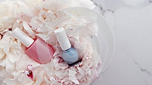 Pastel nail polish bottles and peony flowers, manicure and pedicure set for luxury cosmetics, nailpolish product and