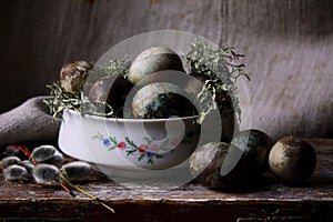 Pastel painted easter eggs in a white bowl.