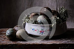 Pastel painted easter eggs in a white bowl.