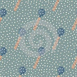 Pastel palette seamless doodle pattern with stylized flail mace shapes. Blue and beige colored weapon on green dotted background