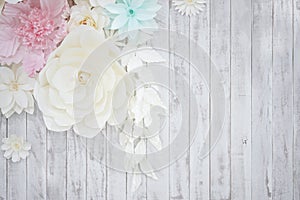 Pastel paper flower cream white pink green blue colour with hand craft art on the white wood plate background