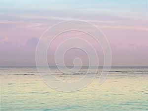 Pastel peaceful scene of a calm ocean sea and sunset sky