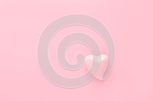 Pastel pink background with a heart with copy space