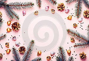 Pastel Pink Christmas Background. Festive frame of fir branches, golden balls and confetti