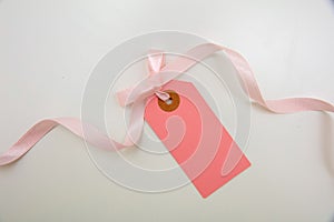 Pastel pink color empty gift card and curly ribbon. Blank price tag isolated on transparent background. PNG