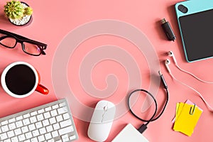 Pastel pink desk office with laptop, smartphone and other work supplies with cup of coffee. Top view with copy space for input the