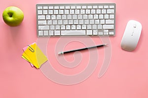 Pastel pink desk office with laptop, smartphone and other work supplies with cup of coffee. Top view with copy space for input the