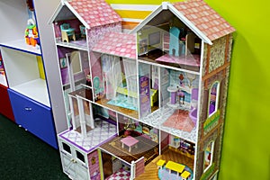 Pastel pink doll house. Games for girls in the entertainment center or at home. Children free time. Retro play kitchen in vintage