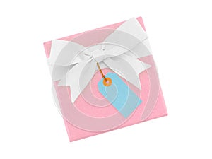 pastel pink gift box with simple ribbon bow and blue price tag isolated on white background