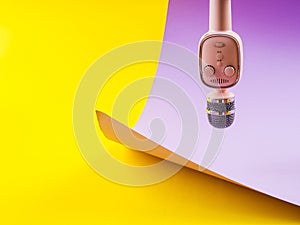 Pastel pink microphone on colorful background