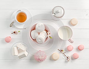 Pastel sweets, tea and milk, topview