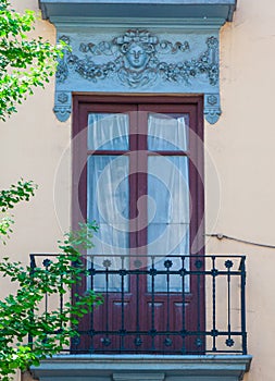 Pastel traditional window and balcony in Spain with stucco decoration