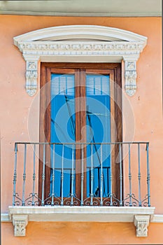 Pastel traditional window in Spain with stucco decoration
