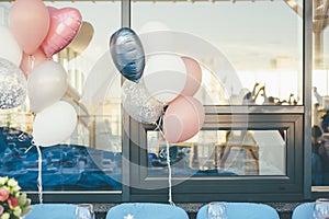 Pastel wedding balloons and wedding ceremony glass reflection