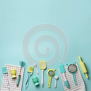Pastel yellow, blue cooking utensils on turquoise background. Food ingredients. Cooking cakes and baking bread concept