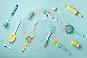 Pastel yellow, blue cooking utensils on turquoise background. Food ingredients. Cooking cakes and baking bread concept