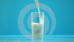 Pasteurized cow milk pouring in glass, organic nutrition, fresh food, calcium