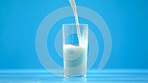 Pasteurized cow milk pouring in glass, organic nutrition, fresh food, calcium