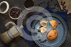 Pasticciotto leccese pastries on a plate near coffe cup and moka on dark table top view