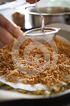 Pastilla filling preparation with icing cinnamon spreaded with straner