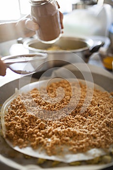 Pastilla filling preparation with icing cinnamon spreaded with straner