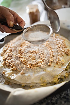 Pastilla filling preparation with icing sugar spreaded with strainer