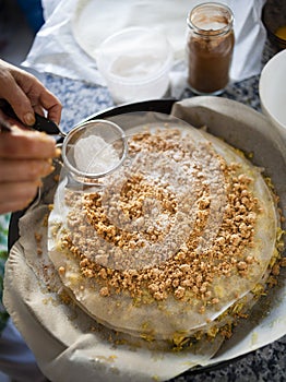 Pastilla filling preparation with icing sugar spreaded with strainer