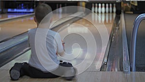 Pastime in bowling. Skating balls on the track with the aim of knocking down pins.