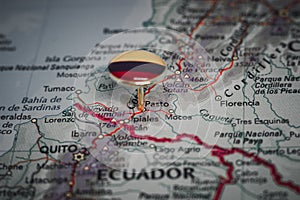 Pasto pinned on a map with the flag of Colombia photo