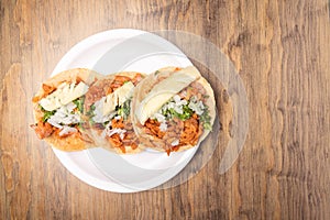 Pastor tacos with corn tortillas. Mexican food. Mexican food concept on wooden table. Traditional mexican food