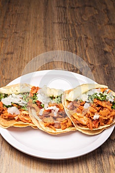 Pastor tacos with corn tortillas. Mexican food. Mexican food concept on wooden table. Traditional mexican food