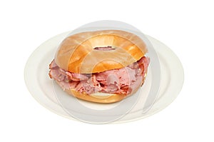 Pastrami in a bagel on a plate