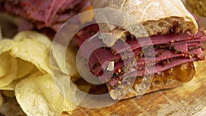 Pastrami sandwhich with delicious meet on baguette bread with chedder cheese, onion