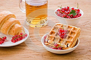 pastries with red berries and a glass of tea/pastries with red berries and a glass of tea. Selective focus