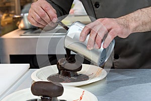 Pastry chef decorating, chef preparing desert chocolate cake