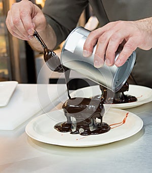 Pastry chef decorating, chef preparing desert chocolate cake
