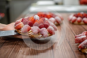 Pastry chef placing a cake