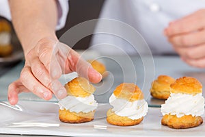 Pastry chef with profiteroles