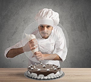 Pastry cook prepares a cake
