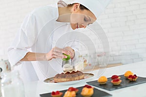 Pastry cook preparing a cake