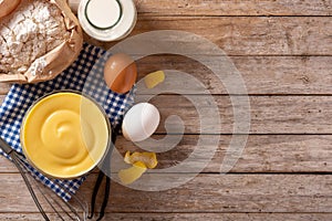 Pastry cream in a bowl and ingredients photo